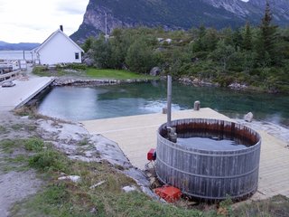 Have You Ever Wanted to Stay in a Norwegian Sea Cabin? - Photo 6 of 8 - When you arrive at Manshausen, you'll find a hot tub that you can enjoy at your leisure. It holds up to 14 people and leads down to a dam that holds salt water that’s pumped into the contained area to keep it fresh.