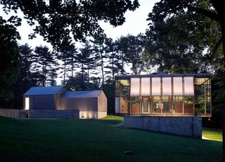After a Year on the Market, Philip Johnson’s Wiley House Drops by $2 Million - Photo 1 of 9 - Built in 1953, the Wiley House is made up of a single glass-and-wood rectangular pavilion that’s perched on top of a rectangular box made of stone and concrete. Johnson chose the six-acre plot of land himself and was particularly fond of the natural slopes of the site, which is surrounded by hickory trees. 