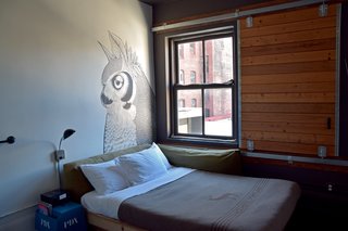 Every room has a different setup, many of which include custom wall murals that are usually quirky and lighthearted. Industrial and rough details make you feel like you’re camping, including wool quilts from Pendleton for the Ace Hotel, barn door sliding windows, heavy metal hardware, and old claw foot bathtubs.