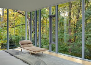 In the master bedroom, Mori custom built a bed with side drawers and lined the space with windows that are outfitted with automatic curtains—both blackout and sheer.