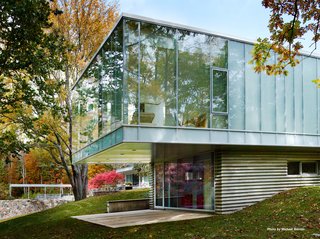 Mori's addition is constructed of steel, concrete, glass, and a bluestone veneer. She decided to preserve the ceiling height of the main house (11'6") and lined the roof with Voltaic solar panels.