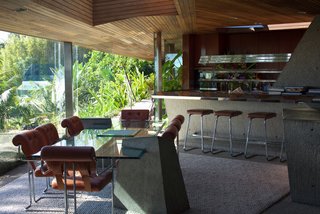 Iconic Perspectives: John Lautner’s Sheats-Goldstein Residence - Photo 4 of 8 - Lautner and Goldstein installed concrete throughout the house, as well as wood on the ceilings—which is what Lautner had originally preferred to do. The glass table in the dining room was a Lautner-designed piece that he created for Goldstein. They installed a skylight above the table that opens up automatically. 