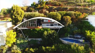 10 Modern Iconic Masterpieces - Photo 6 of 10 - John Lautner’s Garcia House stands on stilts 60 feet above the canyon on Mulholland Drive in Los Angeles. When John Mcllwee and Bill Damaschke purchased the residence in 2002, they began a journey to bring the masterpiece back to life after being passed around by multiple owners since its creation in 1962. 