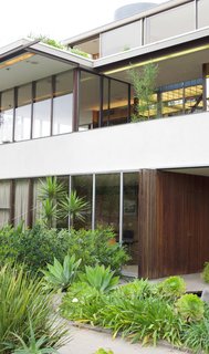 From 1932 to the Present Day—Watch How Technology Continues to Progress in This Iconic L.A. House - Photo 1 of 7 - As seen today, the front facade of Neutra's VDL Studio and Residences in Silver Lake stands proud with a composition of clean lines, sharp angles, and reflective surfaces. The large amount of glass allows you to see directly through the house—further accentuating its relationship to the outdoors. Additionally, the automatic sun louvers that he designed allows the house to adapt to varying temperatures and levels of sun exposure. 