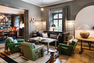 A Visual Journey Through Stockholm's Hotel Ett Hem - Photo 4 of 12 - The communal living room acts a social space where guests can mingle and relax. Cozy furniture and warm lighting makes the space feel more like a home than a hotel.