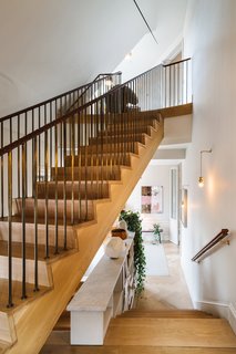 A Visual Journey Through Stockholm's Hotel Ett Hem - Photo 5 of 12 - Though there’s a small elevator that leads to each floor, there’s also a wood-clad staircase with brass handrails that are wrapped with leather. You’ll also find the owners' personal collection of art and photography that's spread throughout each floor.