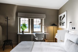 A Visual Journey Through Stockholm's Hotel Ett Hem - Photo 6 of 12 - In this bedroom on the top floor, a desk area overlooks the Östermalm neighborhood and is equipped with heated floors. Each room also has its own brass cocktail cabinet.