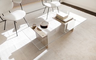 This New Jewelry Showroom Celebrates 'Made in L.A.' From Top to Bottom - Photo 3 of 9 - Jung and Hurewitz designed the custom angular glass and oiled oak coffee table, and set it next to a pair of vintage chairs. The round hand-turned walnut mirrors on the table were also custom produced and provide a space to showcase Lee’s jewelry. 