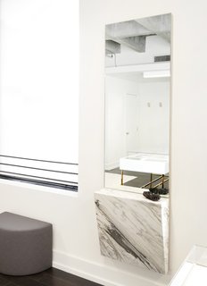 This New Jewelry Showroom Celebrates 'Made in L.A.' From Top to Bottom - Photo 7 of 9 - They affixed a chunk of Mountain Calcutta marble to a wall-mounted mirror to hold jewelry during fittings.