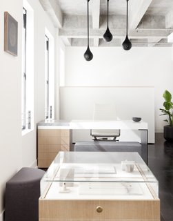 This New Jewelry Showroom Celebrates 'Made in L.A.' From Top to Bottom - Photo 8 of 9 - Above Lee’s custom desk hangs three matte black Drop Light Pendants that were designed by Early Work. 