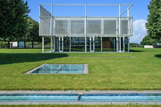 A Thomas Phifer-Designed Glass-and-Steel Masterpiece For Sale - Photo 3 of 14 - The house includes 7,000 square feet of substructure that sits on the underside of the hill from one side, and is open to the sky on the other. The glass plates seen at the forefront of this image serve as skylights to the substructure, which includes an indoor pool, mudroom, library, kitchen, gym, media room, and a walk-in cheese locker and wine room. 