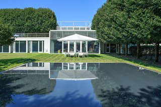 A Thomas Phifer-Designed Glass-and-Steel Masterpiece For Sale - Photo 4 of 14 - A large portion of the home is surrounded by green roof that sits above the substructure. The reflecting pool is shown here, which can be admired from the expansive kitchen's windows.