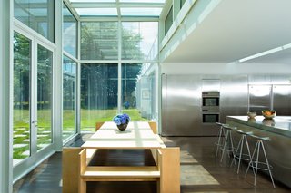 A Thomas Phifer-Designed Glass-and-Steel Masterpiece For Sale - Photo 6 of 14 - Adjacent to the reflecting pool is a chef's kitchen that’s filled with expanses of stainless steel.
