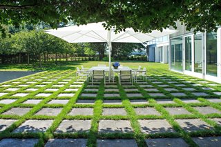 A Thomas Phifer-Designed Glass-and-Steel Masterpiece For Sale - Photo 14 of 14 - Dan Kiley filled the entire property with thoughtful landscape elements, including this patched concrete outdoor dining area. 