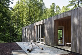 A Cypress-Clad Lake House Posted Up on an Old Logging Road - Photo 3 of 4 - The siding is made up of untreated cypress. You can see how each section has weathered differently, depending on how much exposure it's received since its completion in 2013.<span> <a href="/discover/dwelllpow">#dwelllpow</a></span>