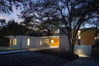 A Glimpse Into a Remodeled Midcentury Abode in Austin - Photo 1 of 4 - The flat-roof structure, which is constructed with metal siding and wood, is located at 1906 Airole Way in Austin, Texas. 