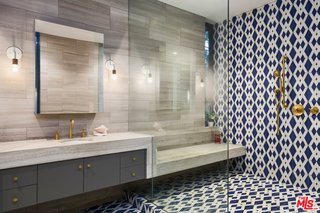 A Glimpse Into a Remodeled Midcentury Abode in Austin - Photo 4 of 4 - The master suite was completely updated with Carrera marble, travertine, and handmade encaustic tile that references elements of Stenger’s original design. 