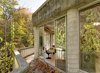 The One-of-a-Kind Home of the Late Architect John Black Lee Drops to $750K - Photo 9 of 10 - You can walk along the thin balcony that lines the edge of the house, where you’ll enjoy incredible views of the river.