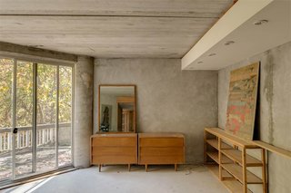 The One-of-a-Kind Home of the Late Architect John Black Lee Drops to $750K - Photo 10 of 10 - Black was a supporter of the Glass House School of modern residential architecture that flourished in New Canaan in the midcentury era. This house is no exception as it’s filled with a substantial amount of glass—and concrete, of course. It’s finished with Thermopane Windows throughout. 