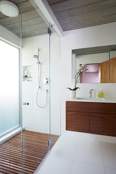Same Bones, New Materials—A Double Gable Eichler Gets a Dashing Update - Photo 8 of 9 - The larger master bathroom was reoriented and updated with new materials—the same ones that have been used throughout the house, including walnut and Western red cedar siding. 