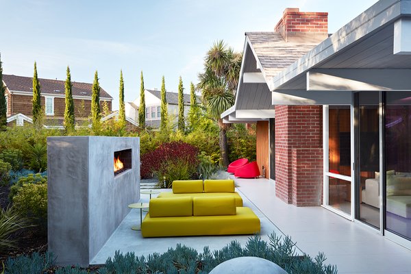 Same Bones, New Materials—A Double Gable Eichler Gets a Dashing Update - Photo 9 of 9 - Outer Space Landscape Architects built a custom fireplace in the backyard, which acts as a backstop for the seating area. 