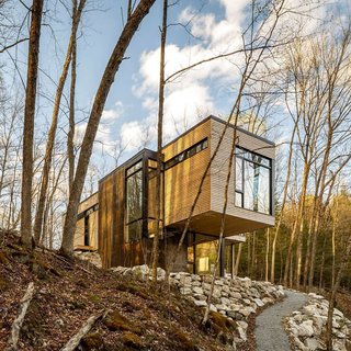 This Cedar-Wrapped Cabin Mimics its Natural Surroundings With Ease - Photo 3 of 3 - Christopher Simmonds Architect left the eastern white cedar on the exterior untreated in order to allow it to age naturally. 