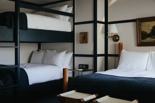 Modern Equestrians Will Find Themselves at Home at This New Americana Hotel - Photo 3 of 7 - The beds are topped off with custom hand-dyed French linen blankets from Brooklyn-based Sharktooth. Additionally, each room is finished with high-gloss painted plywood floors that have a decorative wood trim running the edge of the room. 