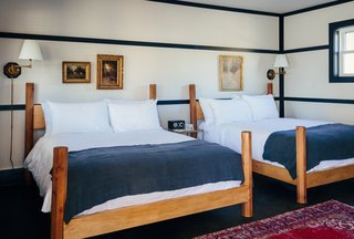 Modern Equestrians Will Find Themselves at Home at This New Americana Hotel - Photo 2 of 7 - The twelve classic bedrooms are filled with raw brass light fixtures and beds that are custom designed by woodworker David E Cummings. Marked by octagonal posts, the frames are made out of solid pine and are handcrafted in his upstate studio. 