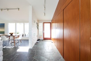 If You Crave Bright, Light-Filled Spaces, This Midcentury Home For Sale Could Be the One - Photo 5 of 9 - Similar to other Fickett homes—which the neighborhood is filled with—it includes original paneling throughout the home and brickwork that’s been painted white. 