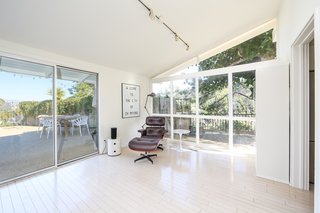 If You Crave Bright, Light-Filled Spaces, This Midcentury Home For Sale Could Be the One - Photo 6 of 9 - A corner of the open living space looks out to the outdoor living areas through extensive glass, original skylights, and an angular clerestory design—all of which invite natural light in.