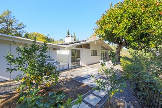 If You Crave Bright, Light-Filled Spaces, This Midcentury Home For Sale Could Be the One - Photo 1 of 9 - At the Matson Residence, a side yard allows the current homeowners’ daughter to play outside without them having to worry about the pool. 