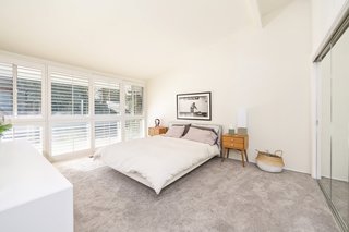 If You Crave Bright, Light-Filled Spaces, This Midcentury Home For Sale Could Be the One - Photo 7 of 9 - A past renovation included installing carpets into the bedrooms, which have been left clean and simple.