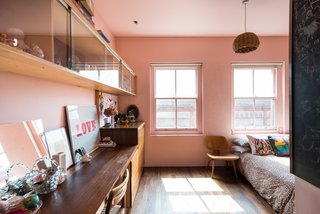 The second floor holds two bedrooms, including a room that has a "windowed cockpit," which Brinkworth designed for the owners’ children to look out over the garden. 