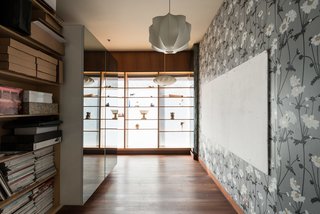 The home includes a basement that has a laundry room and a miscellaneous space that the recent owners have turned into a workshop and store room. This gallery-like room displays collections of cherished objects along with a mix of hanging pendant lamps by George Nelson. 