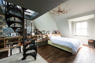 The whole third floor is dedicated to a double-height master bedroom, which contains its own set of original wrought-iron spiral stairs. 