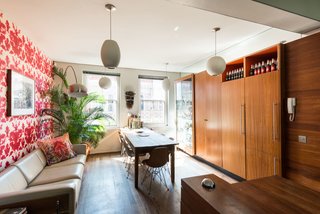 The dining space and kitchen are connected in a long, narrow space that's lined with floor-to-ceiling cabinets. 