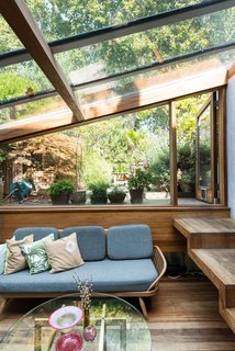 One of the additions that took place during Brinkworth’s second phase of extensions is the glazed garden room, which sits half a level below the first floor. Handcrafted wooden steps lead to a terraced garden outside.
