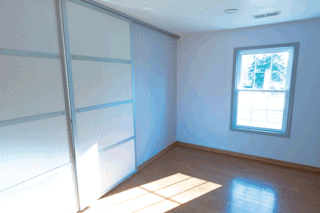 The Winning Vision From a Universal Design Competition Is Brought to Life For a Veteran - Photo 6 of 8 - Large rolling doors create easy-to-maneuver dividers between the living space and the bedrooms.