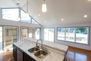 The Winning Vision From a Universal Design Competition Is Brought to Life For a Veteran - Photo 3 of 8 - One of the other main plans the architecture team proposed was to build a glass addition on one end of the house that would introduce natural light into the kitchen and dining area. 