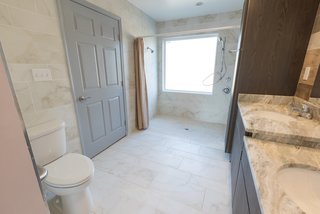 The Winning Vision From a Universal Design Competition Is Brought to Life For a Veteran - Photo 8 of 8 - The final result includes an accessible layout with plenty of storage space and dual sinks at different levels for both the adults and the young ones.