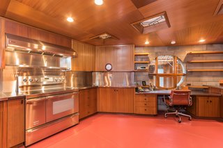 Frank Lloyd Wright’s Last Major Residential Masterpiece Could Be Yours for $8 Million - Photo 6 of 11 - Though the appliances have been updated, the rest of the kitchen is original, including the cabinets, piano hinges, and the painted glass windows on the ceiling. 