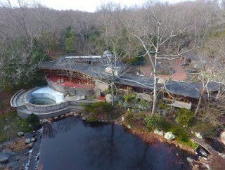 Frank Lloyd Wright’s Last Major Residential Masterpiece Could Be Yours for $8 Million - Photo 11 of 11 - An overhead drone view shows the 15-acre property that also hosts a heated pool, river, tennis court, barn/stable, sculpture path, and rooftop observatory. The original landscaping was designed by Frank Okamura and Charles Middeleer. 