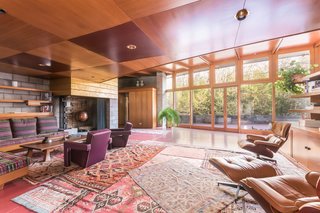 Frank Lloyd Wright’s Last Major Residential Masterpiece Could Be Yours for $8 Million - Photo 4 of 11 - The original living room holds a number of furniture pieces that Wright designed. Since he enjoyed interweaving textures and materials, he created a fireplace that’s made of concrete block—but painted with gold leaf. Gricar explains, "He loved the material play between fancy and utilitarian." 