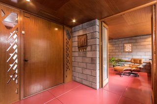 Frank Lloyd Wright’s Last Major Residential Masterpiece Could Be Yours for $8 Million - Photo 2 of 11 - The interior of the home is almost completely lined with mahogany, along with sections of concrete blocks. Wright’s design called for different cuts of wood to be placed together, which creates a rich layered effect. 
