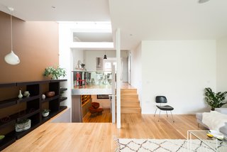 A Fusion of Old and New Makes this Home For Sale Shine on London’s Womersley Road - Photo 5 of 8 - The home's interesting layout becomes clear from this view, which shows the glass balustrade that separates the dining room from the sitting room. The lower steps to the left lead to a media room on the lower ground floor, which then connects to a guest bedroom with an en-suite bathroom.