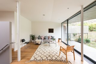 A Fusion of Old and New Makes this Home For Sale Shine on London’s Womersley Road - Photo 4 of 8 - By following a set of steps, you enter into a sitting room that’s part of the extension that was built towards the rear of the house. A large sliding wall of glazed glass from Fineline opens to the yard.