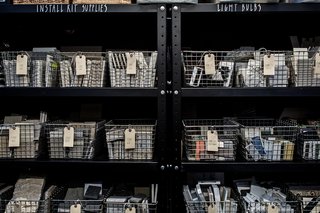 A San Francisco Design Collective Reveals its Impeccably Cool Creative Studio - Photo 11 of 12 - Their materials library is partitioned from the open space with charred wood walls that have been turned black with the Japanese Shou Sugi Ban technique. Shown here is the storage side of this wall.