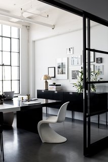 A San Francisco Design Collective Reveals its Impeccably Cool Creative Studio - Photo 6 of 12 - Hollis shares this office with her husband and CEO, Lewis Heathcote. Panton Chairs, designed by Verner Panton for Vitra, can be found in various areas of the office. Poured concrete floors are kept consistent throughout the space.