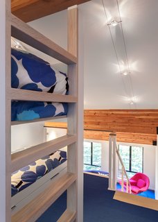 When the family visits the vacation home, the kids sleep in custom bunk beds in the open loft. 