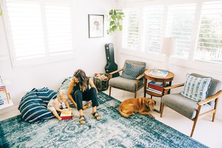 Grant Ellis’s wife Julie and daughter Kaia are shown here in their cozy, indigo-filled living room in Cardiff, California. 